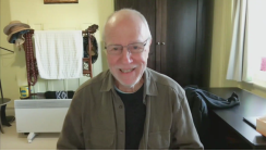 A person wearing glassesDescription automatically generated with low confidence
